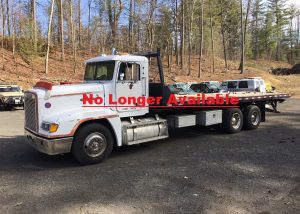 Freightliner Rollback Tow Truck. 1989 FLD 120 with a Caterpillar 14.6 liter six cylinder diesel motor with 704'116 miles. The transmission is an Eaton Fuller Road Ranger performance 9 speed with low. It has air ride suspension. The trucks fitted with a Jarr-Dan roll off flatbed and a Ramsey heavy duty winch. Measurements for the flatbed are 28 feet long by 8 feet wide and sits 4 feet 4 1/2 inches off the ground. The truck has AC, air ride driver seat, heated mirrors, engine break. The trucks GVWR is 40'000 lbs.