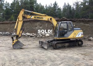 Kobelco Hydraulic Excavator. 1998 model Mark IV SK 115 DZ with 7939 hours. New chains put on the machine along with a new front left idler. Additionally there are newer hoses and a new rebuilt injector pump. The excavators weight is 28'400 lbs. The cab has working heat. The bucket is 24 inches and it has a 4 foot manual thumb. The grading blade is 8' 6" wide and 24" high. Good running machine. Good pads and sprockets with repair to left side track finals needed.