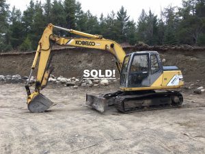 Kobelco Hydraulic Excavator. 1998 model Mark IV SK 115 DZ with 7939 hours. New chains put on the machine along with a new front left idler. Additionally there are newer hoses and a new rebuilt injector pump. The excavators weight is 28'400 lbs. The cab has working heat. The bucket is 24 inches and it has a 4 foot manual thumb. The grading blade is 8' 6" wide and 24" high. Good running machine. Good pads and sprockets with repair to left side track finals needed.