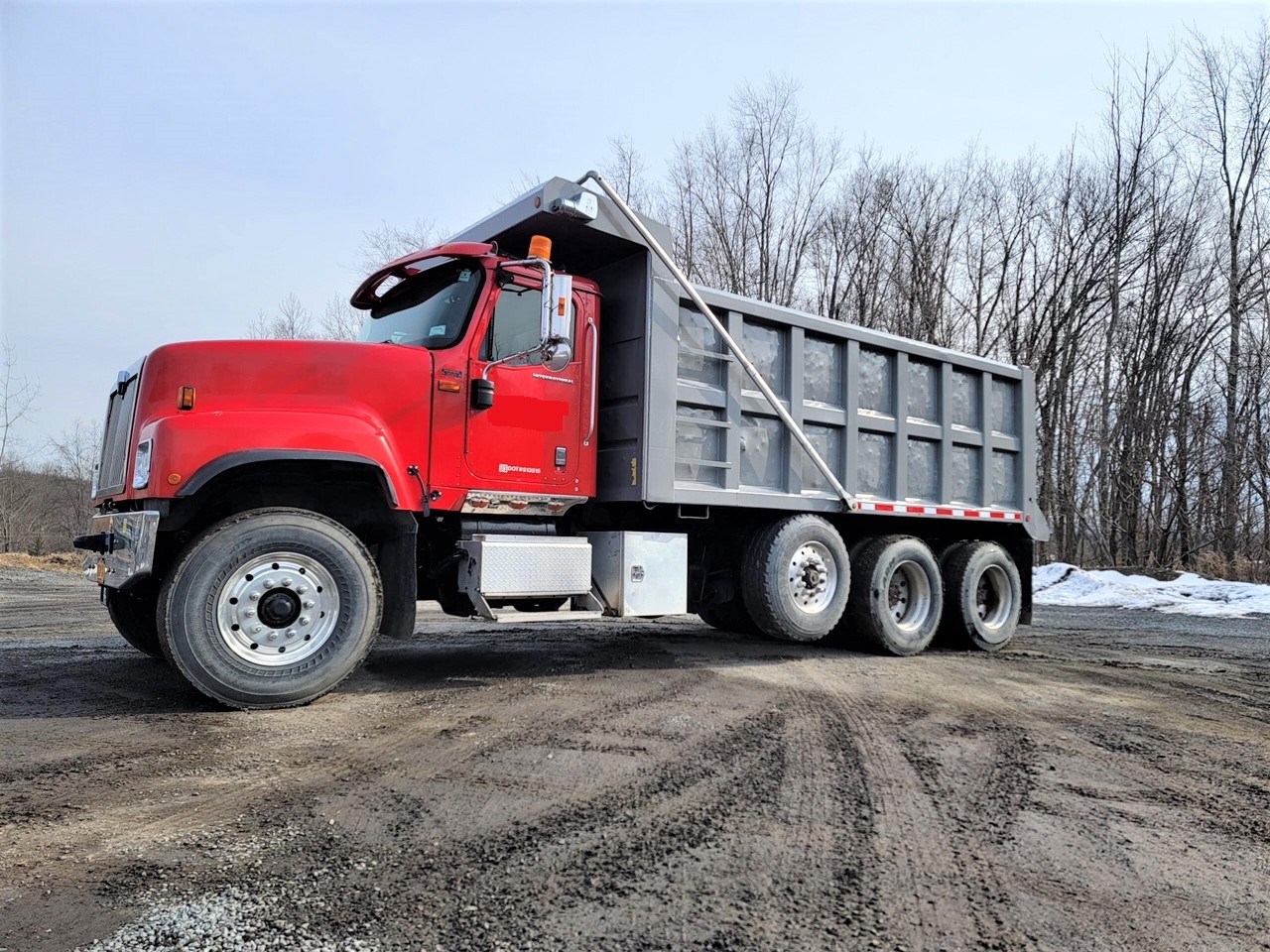 International Tri Axle Dump Truck. 2006 Paystar with 235368 miles. ISX Cummins 500 horsepower diesel engine with a three stage engine brake. 18 speed Eaton Fuller transmission with double locking rears. 20k lb. fronts, 20k lb. steerable lift axle and 46k lb. rears. All new in rear Chalmers suspension package for supper comfortable control and ride. 242 inch wheelbase. 17.5 foot long by 5 foot high steel dump box sandblasted and repainted outside. Interior Eagle package design with power windows, power locks, cruise control, heated mirrors, heat/AC, AM/FM CD player and air ride drivers seat.