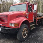 International 4900 Automatic Flatbed. 1999 4x2 single axle truck. DT466 diesel engine with 310'308 driven miles. Five speed automatic transmission. Newer tires all around. 15 foot bed. 194 inch wheelbase and air brakes. Strong running former lumber store truck.