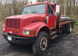 International 4900 Automatic Flatbed. 1999 4x2 single axle truck. DT466 diesel engine with 310'308 driven miles. Five speed automatic transmission. Newer tires all around. 15 foot bed. 194 inch wheelbase and air brakes. Strong running former lumber store truck.